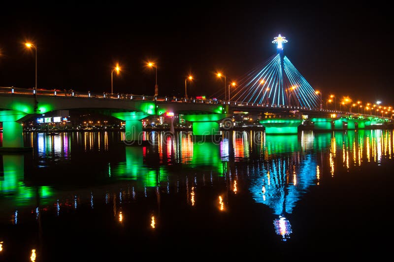 Illumination on Han River Bridge in Danang. The bridge crosses the Han River but in the middle of the night it swings on its axis to allow shipping traffic to pass along the river. Illumination on Han River Bridge in Danang. The bridge crosses the Han River but in the middle of the night it swings on its axis to allow shipping traffic to pass along the river.