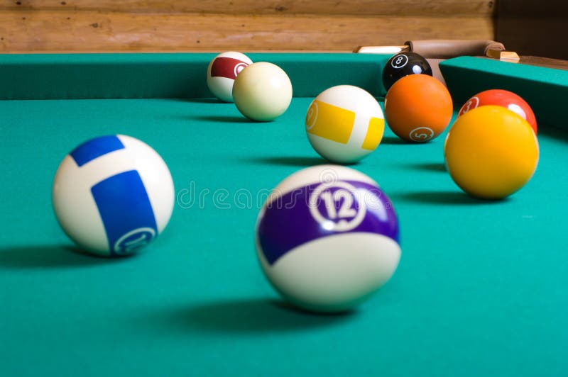Pool balls. Balls for playing pool on a billiard table focus in the background.