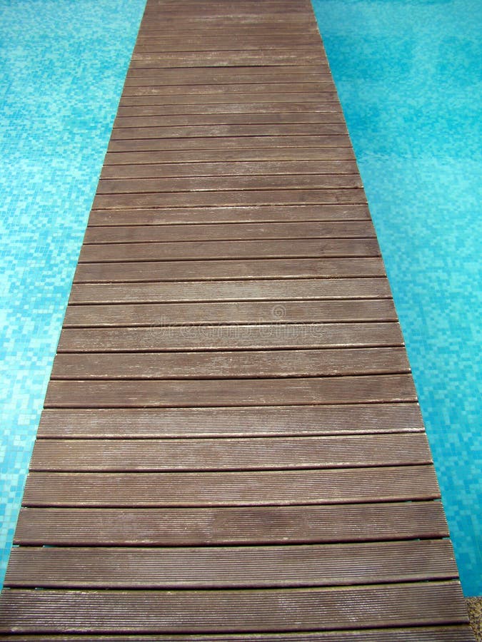 Wood bridge across swimming pool. Wood bridge across swimming pool