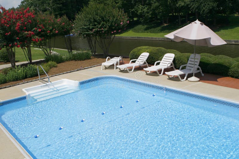 Pool Side with Lounge Chairs and Umbrella