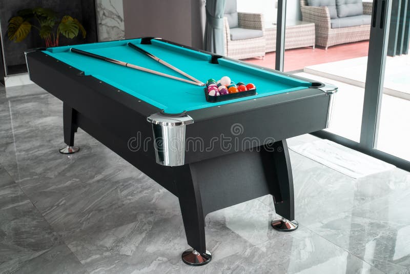 Pool Table or Billiard Table and Sticks in the Living Room Stock Photo