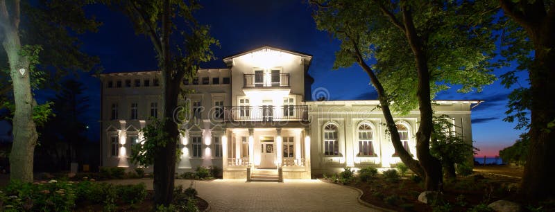 A night view of the Apollo hotel in Darlowo, Poland. Alley and park in front of the hotel. A night view of the Apollo hotel in Darlowo, Poland. Alley and park in front of the hotel.