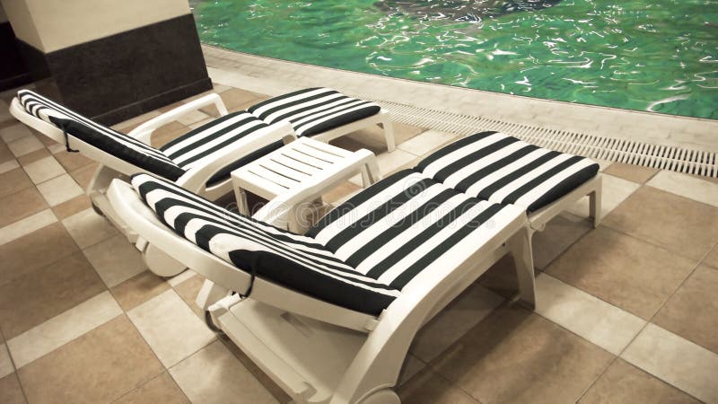 Poolside deck chairs stock photo