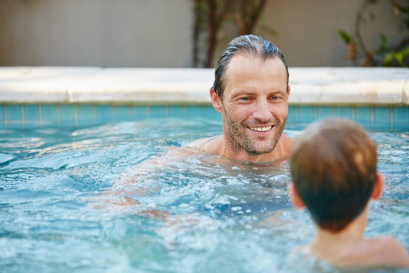 Poolside Fun. a Father and Son Swimming in a Pool Together. Stock Image