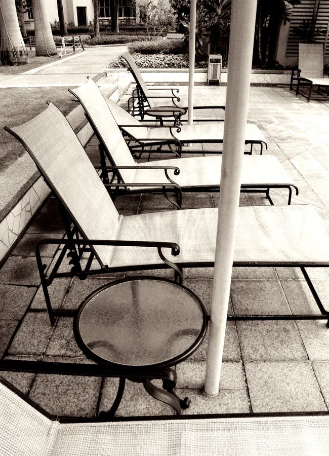 Poolside loungers, monochrome royalty free stock image