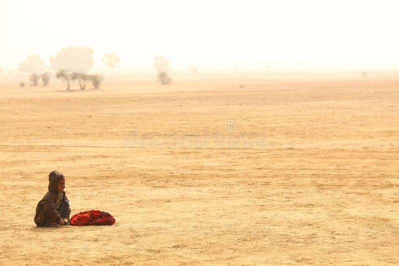 Poor child in sand desert Rajasthan India