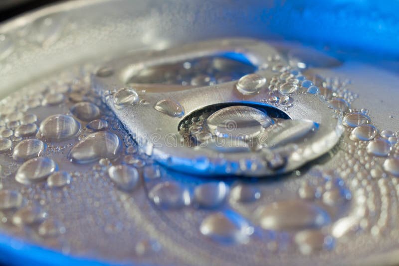 Pop cans with drops of water closeup in blue light.