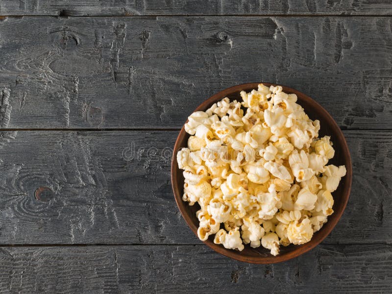 Popcorn in a clay bowl. Place for your text. The view from the top.