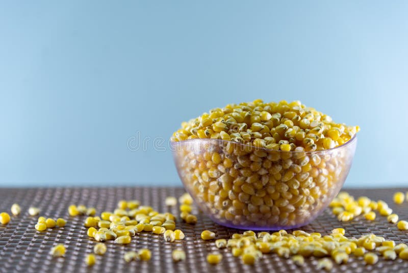 Popcorn Corn Grains on a Kitchen Table and Household Items Stock Photo