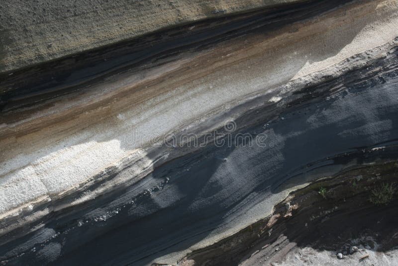 Ash deposits layered over time as different volcanic eruptions took place in the Canary Islands, Tenerife (Teide is the volcano that is responsable for that). Ash deposits layered over time as different volcanic eruptions took place in the Canary Islands, Tenerife (Teide is the volcano that is responsable for that).