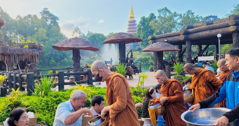 Buengkan,Thailand-January 1,2024 : The monks ask for alms at Phutok temple for celebration new year of buddhist. Buengkan,Thailand-January 1,2024 : The monks ask for alms at Phutok temple for celebration new year of buddhist