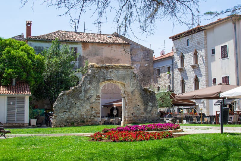 Porec Parenzo, Croatia; 7/19/19: Remains of an arched Roman Gate in a park in the old town of Porec also called Parenzo, in