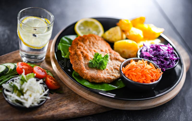 Pork Cutlet Coated with Breadcrumbs with Potatoes and Salads Stock Photo Image of cotoletta