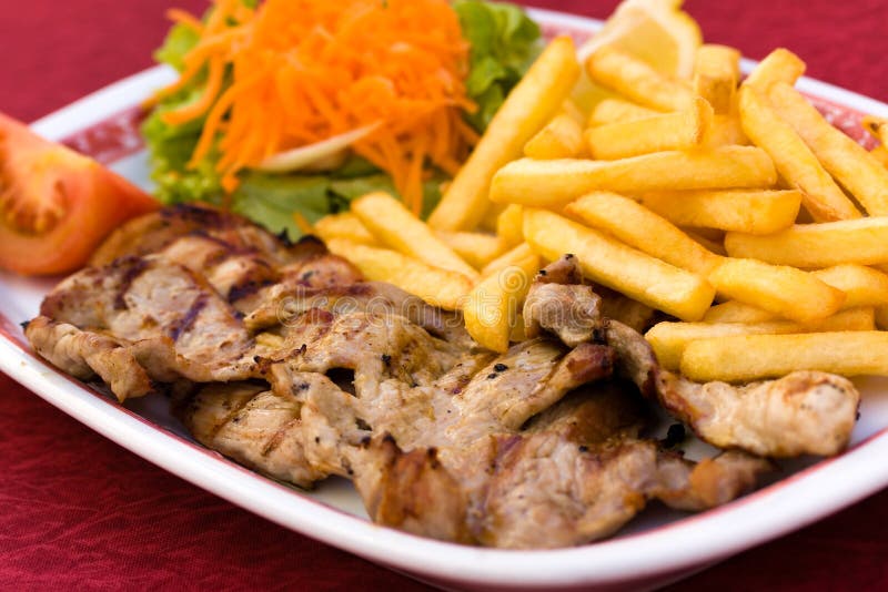 Pork Chop with french fries and salad of carrot an