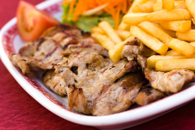 Pork Chop with french fries and salad of carrot an