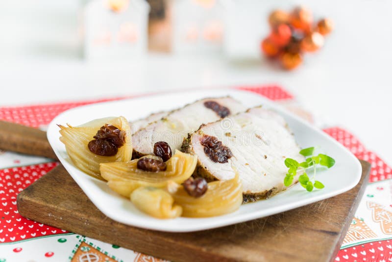 Pork chops stuffed with cranberries and garlic in onion sauce