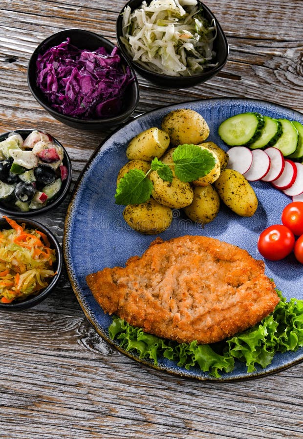 Pork Cutlet Coated with Breadcrumbs with Potatoes and Salads Stock Image Image of pork, plate