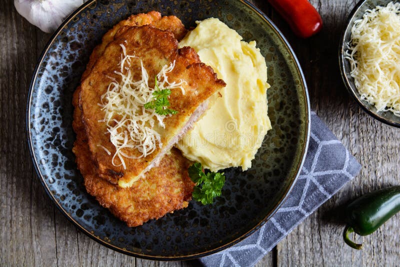 Pork Cutlets Coated in Potato Batter, Studded with Cheese and Served with Mashed Potato Stock