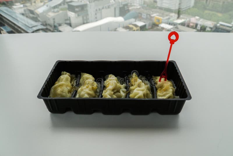 Pork dumpling in black container with red fork royalty free stock image Pork dumpling in black container with red fork royalty free stock image