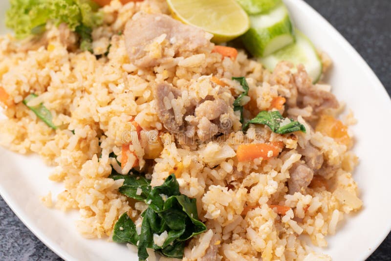Pork Fried Rice on a White Plate on a Black Background Stock Image