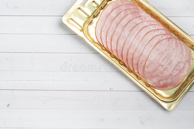 Pork Ham in Thin Slices in a Vacuum Package on the Table. Meat Sliced