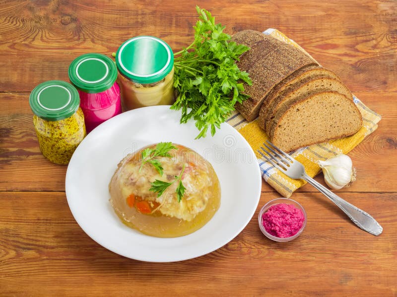Pork jelly on white dish, bread, fork and different seasoning stock photo Pork jelly on white dish, bread, fork and different seasoning stock photo