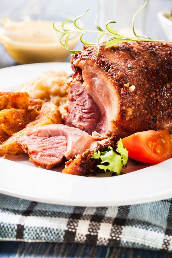 Pork Knuckle with Fried Sauerkraut and Baked Potatoes Stock Photo