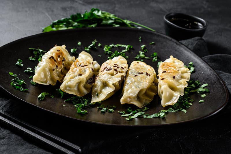 Pork Potstickers on rustic black table. Dim sum on a plate. Top view royalty free stock photos Pork Potstickers on rustic black table. Dim sum on a plate. Top view royalty free stock photos