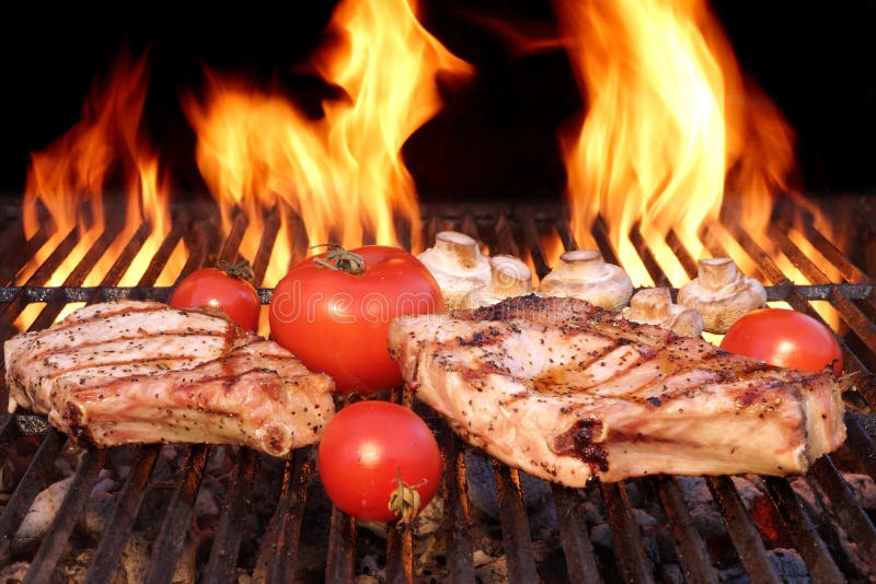 Pork Rib Steak, Tomato And Mushrooms On Hot BBQ Grill