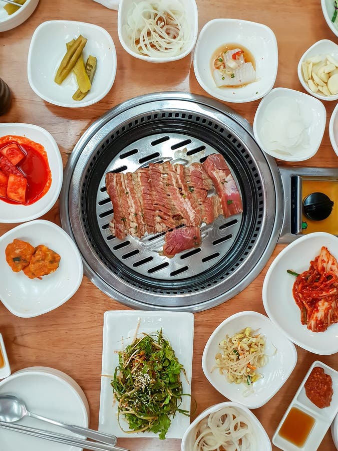Pork Roast with Sets of Korean Side Dishes and Vegetable Stock Image