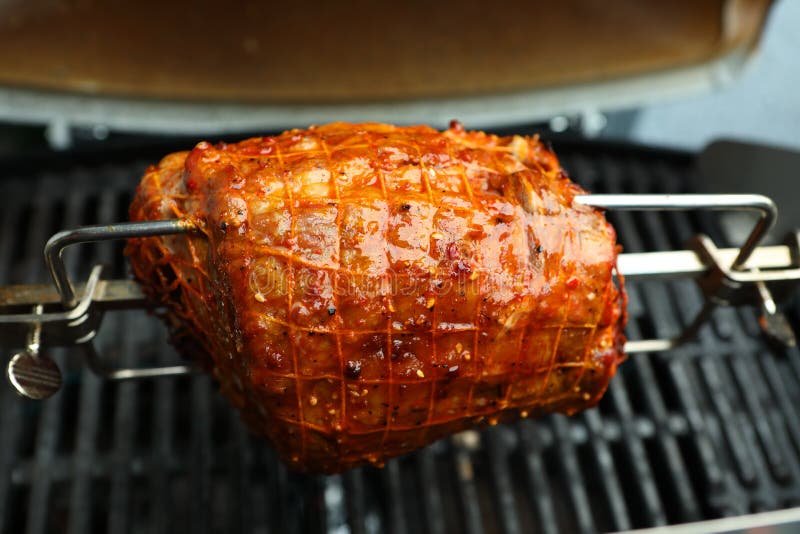 A pork roast on a spit stock image. Image of pork, grilled 104693589