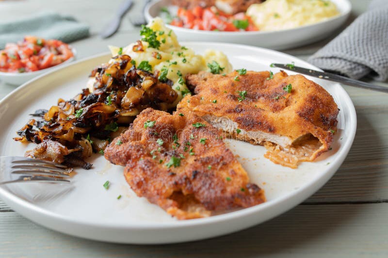 Pork Schnitzel with Fried Onions and Mashed Potatoes on a Plate Stock