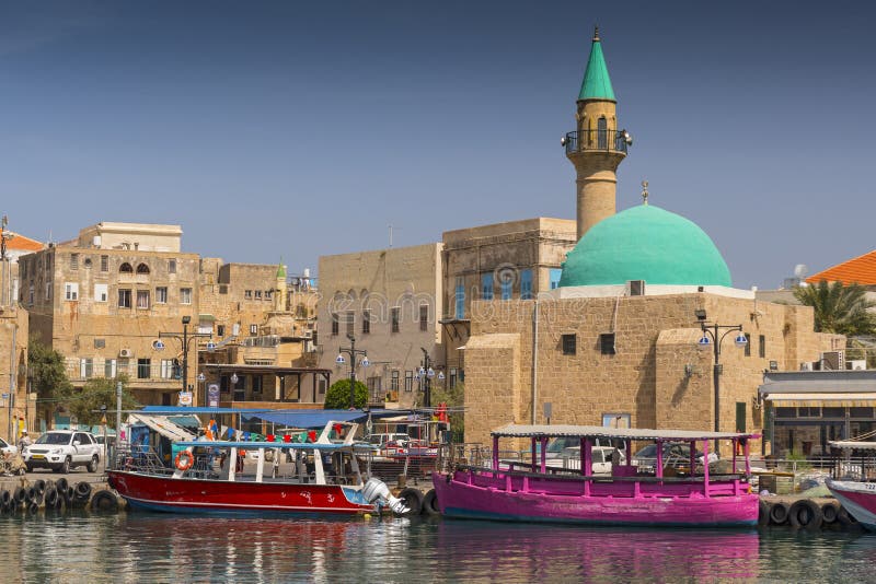 Port of Akko Acre with boats and mosque and the old city in the background, Israel.