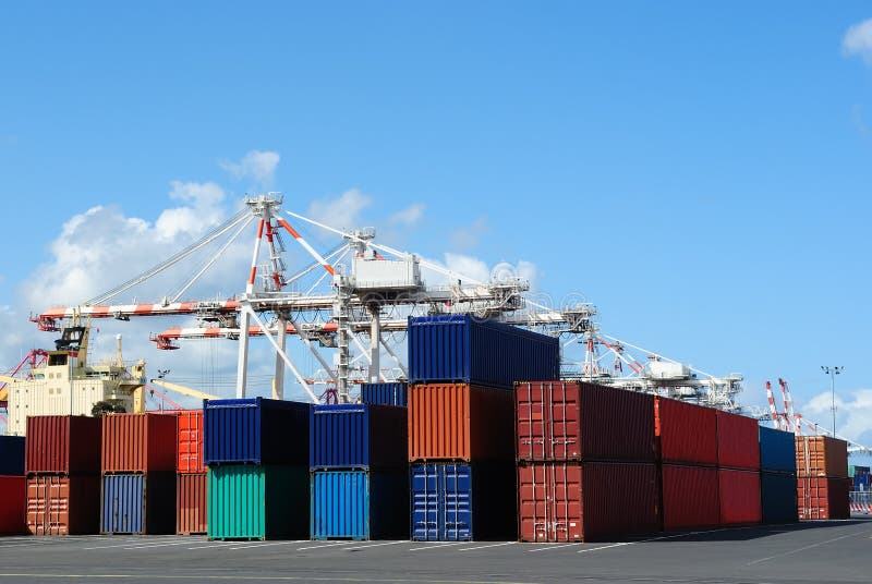 Port cranes and stacks of shipping containers royalty free stock photos