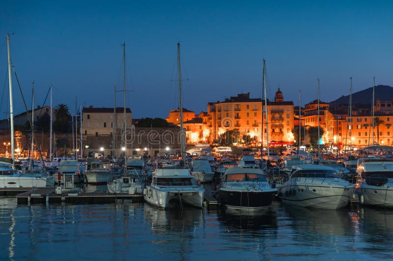 Pleasure yachts and motor boats moored in port of Ajaccio at night, Corsica island, France. Pleasure yachts and motor boats moored in port of Ajaccio at night, Corsica island, France