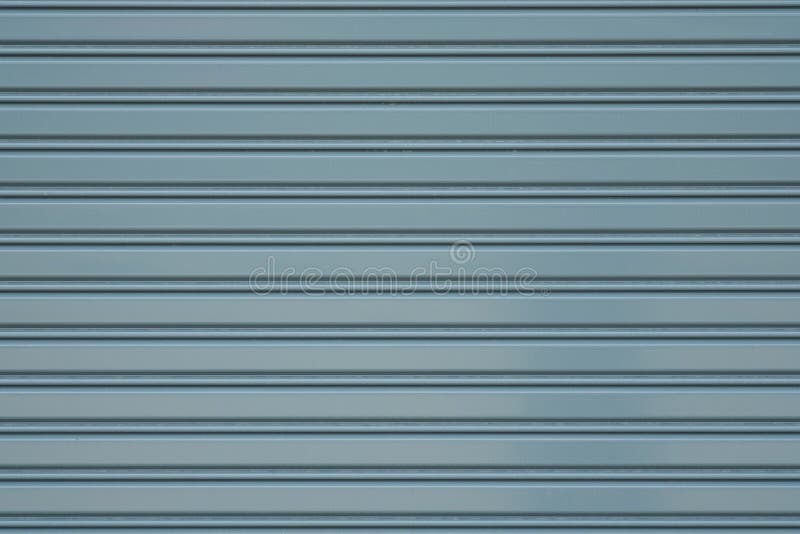Porta cinzenta do obturador do rolo do metal ou fundo fechado da parede da porta fotografia de stock royalty free Porta cinzenta do obturador do rolo do metal ou fundo fechado da parede da porta fotografia de stock royalty free