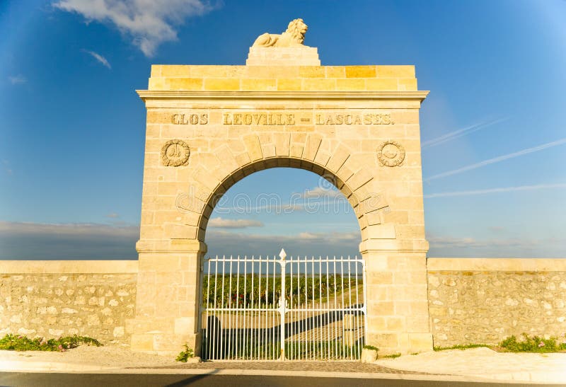Marble gate in the shape of arc to Chateau Leoville-Lascases vineyard in region Medoc, Bordeaux, Franc. Marble gate in the shape of arc to Chateau Leoville-Lascases vineyard in region Medoc, Bordeaux, Franc