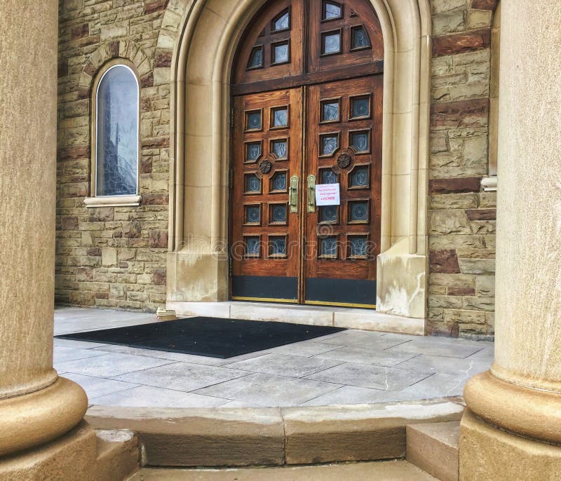 Toronto, Ontario, Canada - Our Lady of Perpetual Help Church door with sign reading all masses cancellation due to COVID-19. Toronto, Ontario, Canada - Our Lady of Perpetual Help Church door with sign reading all masses cancellation due to COVID-19