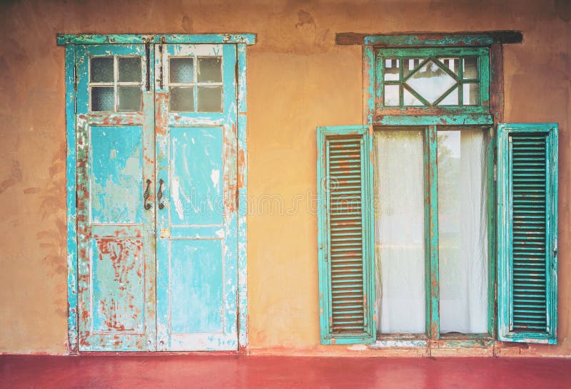 Vintage style old house door and window. Vintage building and old aged design. Grunge old colorful paint. Vintage style old house door and window. Vintage building and old aged design. Grunge old colorful paint.