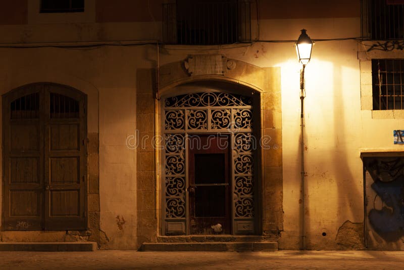 Porta no EL do bairro carregado na noite com luzes de rua, Barcelona, Espanha imagem de stock Porta no EL do bairro carregado na noite com luzes de rua, Barcelona, Espanha imagem de stock
