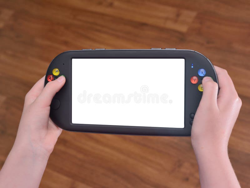 The portable game console in children`s hands, on a wooden background stock images The portable game console in children`s hands, on a wooden background stock images