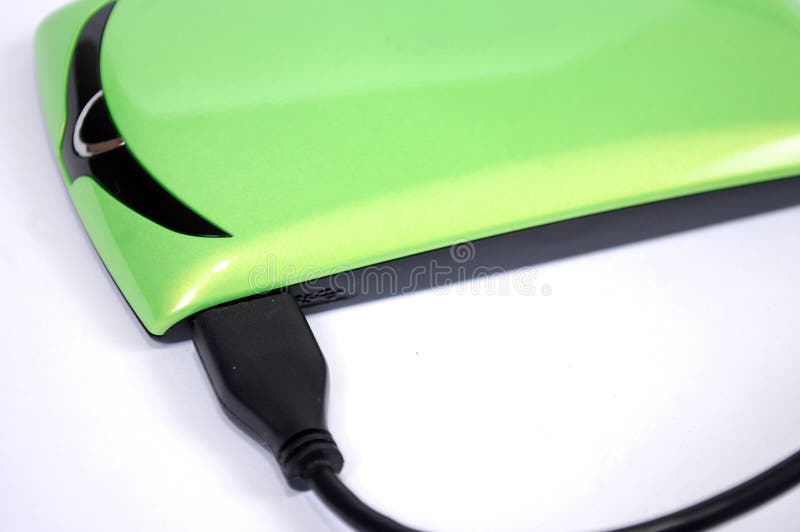 The portable hard drive for the computer with the connected wire on a white background. royalty free stock image The portable hard drive for the computer with the connected wire on a white background. royalty free stock image