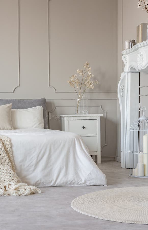 Portale di legno bianco del camino in bella camera da letto interna con gli strati bianchi su letto a due piazze fotografie stock libere da diritti Portale di legno bianco del camino in bella camera da letto interna con gli strati bianchi su letto a due piazze fotografie stock libere da diritti