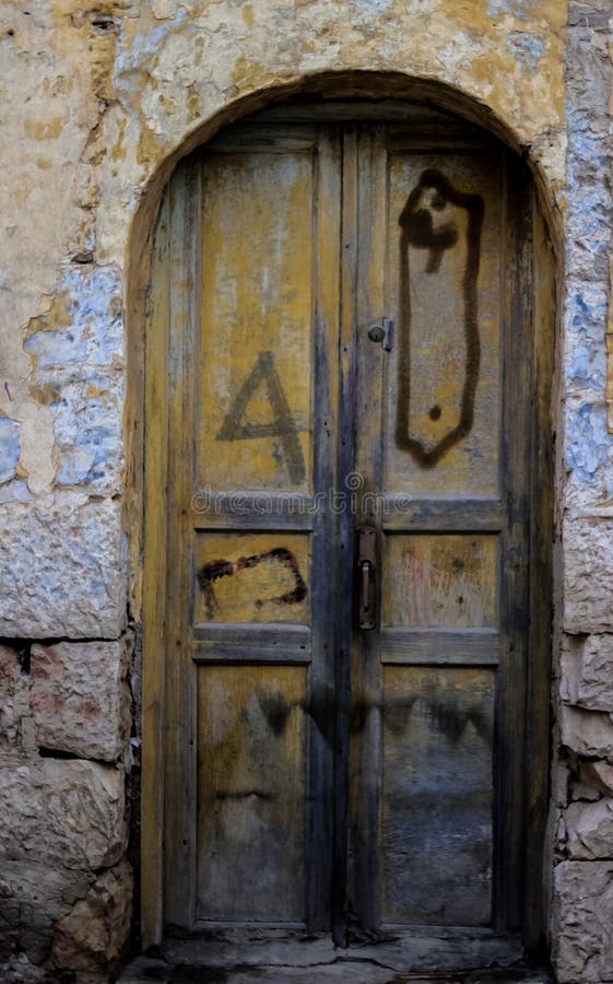 Blue durty, dirty door with rusty and openwork on stone wall a beautiful vintage background. Blue durty, dirty door with rusty and openwork on stone wall a beautiful vintage background