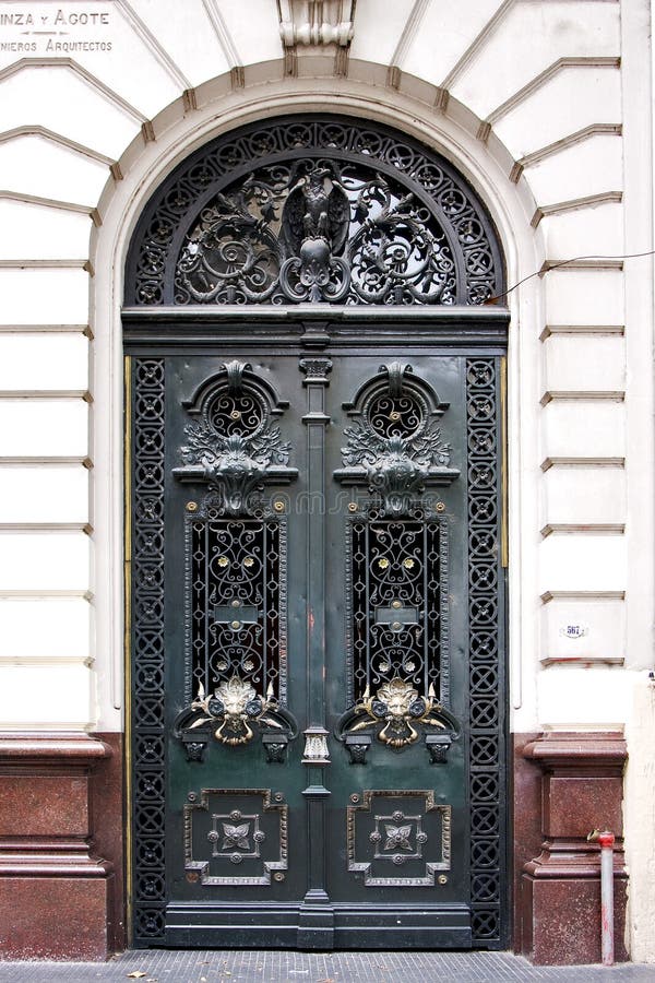 Brown wood old green door and head of lion in a house the centre buenos aires argentina. Brown wood old green door and head of lion in a house the centre buenos aires argentina