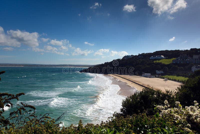 Porthminster beach St Ives Cornwall England with white waves and blue sea and sky
