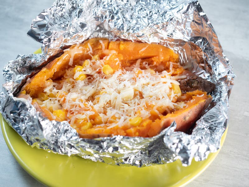 Baked sweet potato in foil stock image. Image of cheese 204210331