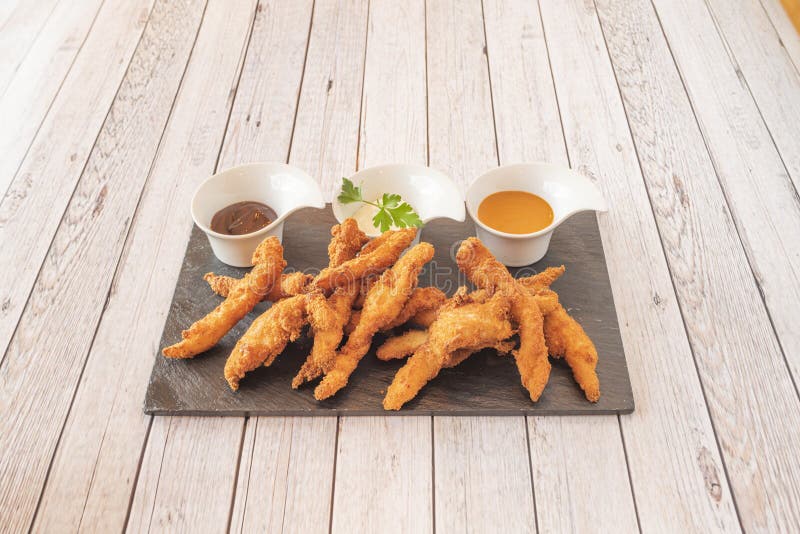 Portion of Chicken Strips Battered and Fried in Olive Oil with Three