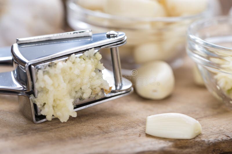 Portion of Crushed Garlic stock photo. Image of steel 48506944