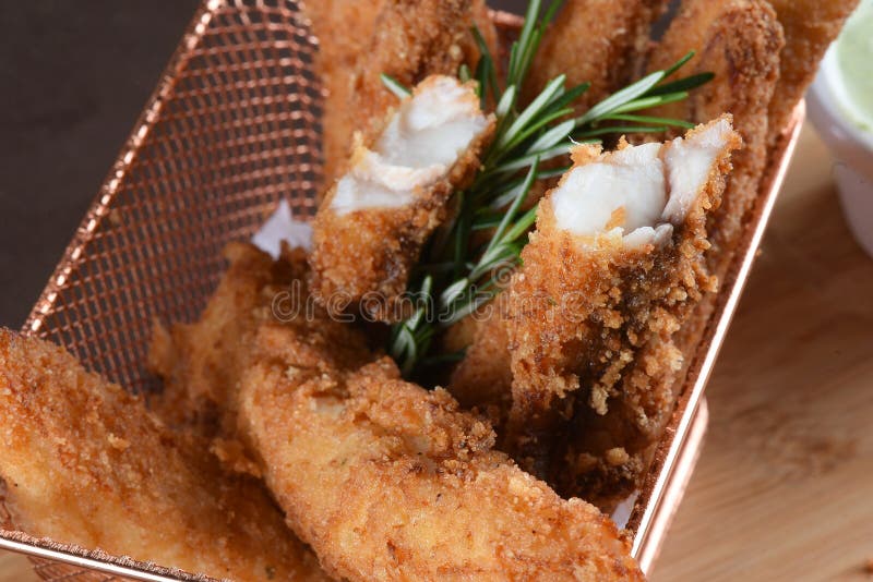 Portion of Fried Fish, Fried Chicken Strips Inside Metal Basket Tasty